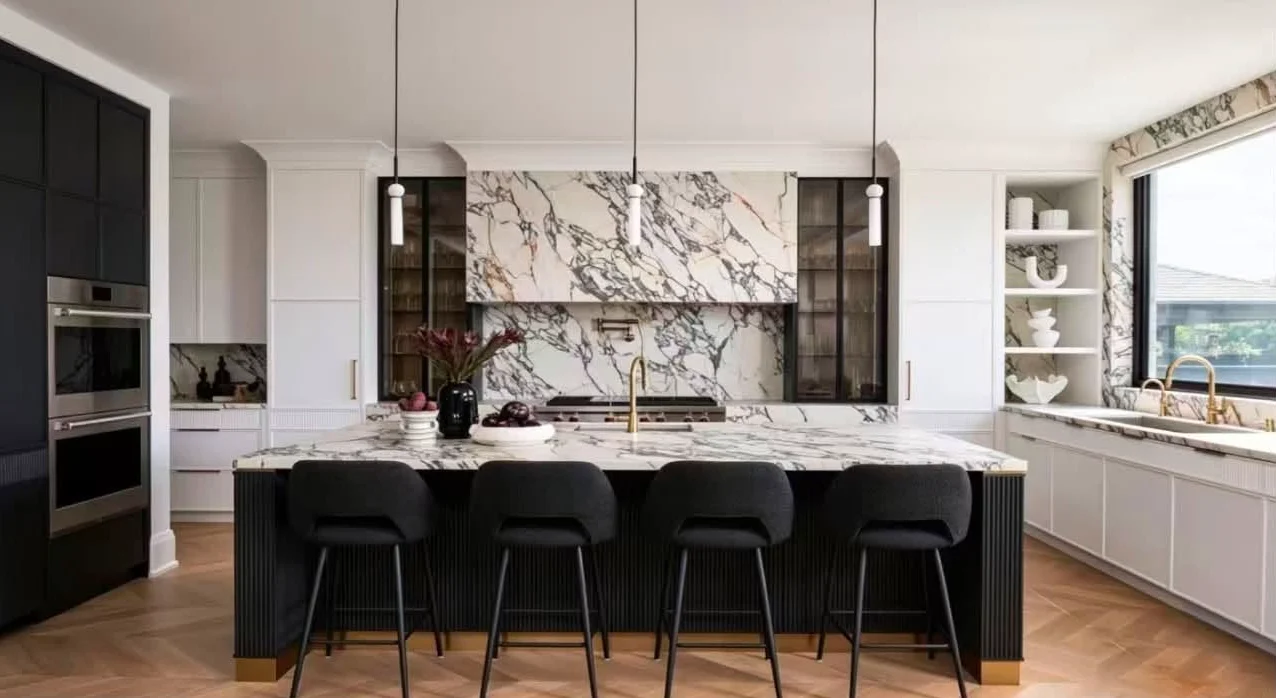 Bright renovated kitchen with a marble island and pendant lighting