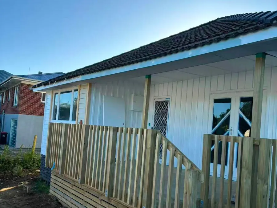 Timber fencing and deck rail beside a house