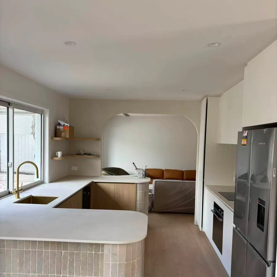 Renovated kitchen with curved island and new benchtop