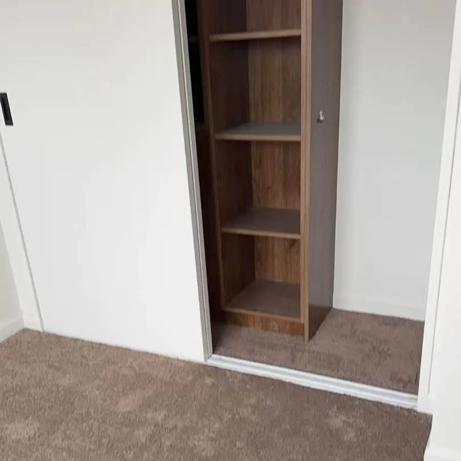 Built-in timber shelving fitted into an alcove
